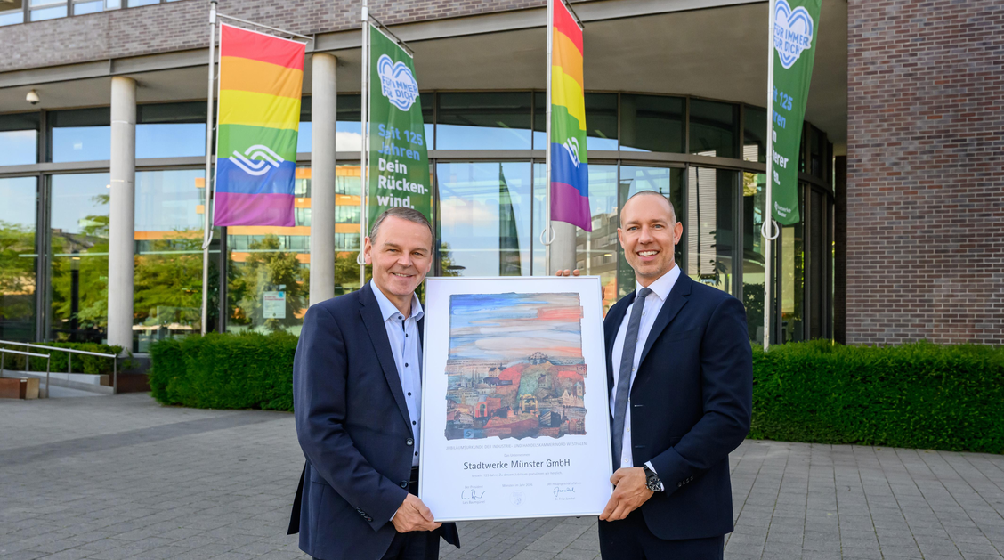Dr. Fritz Jaeckel, Hauptgeschäftsführer der IHK Nord Westfalen, (l.) überreicht zum 125-jährigen Jubiläum eine Urkunde an Stadtwerke-Geschäftsführer Sebastian Jurczyk.