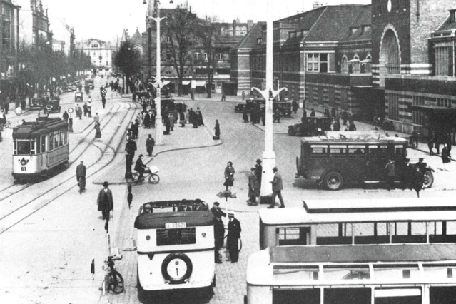 Der Bahnhof Münsters mit Vorplatz, einer Straßenbahn und Bussen
